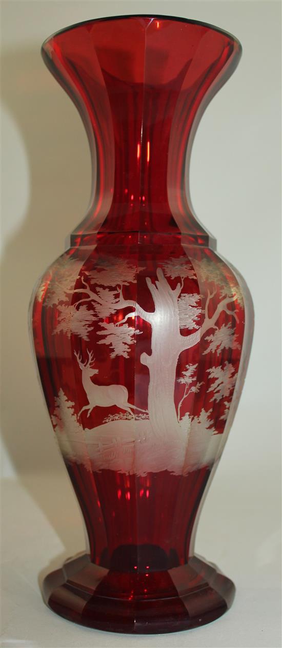 A Bohemian ruby glass multi-facetted baluster vase, late 19th century, 31.5cm